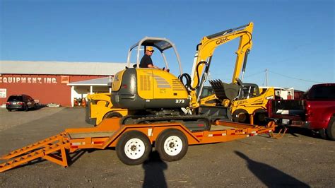 mini excavator loaded in a pickup truck|mini on flatbed truck.